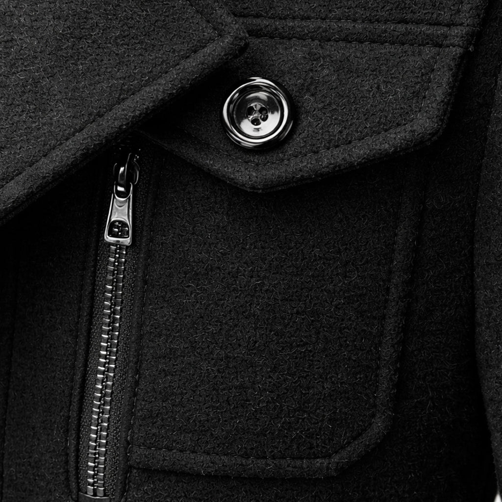 Men's wool-blend coat detail: front zipper pull and round metal button on dark fabric