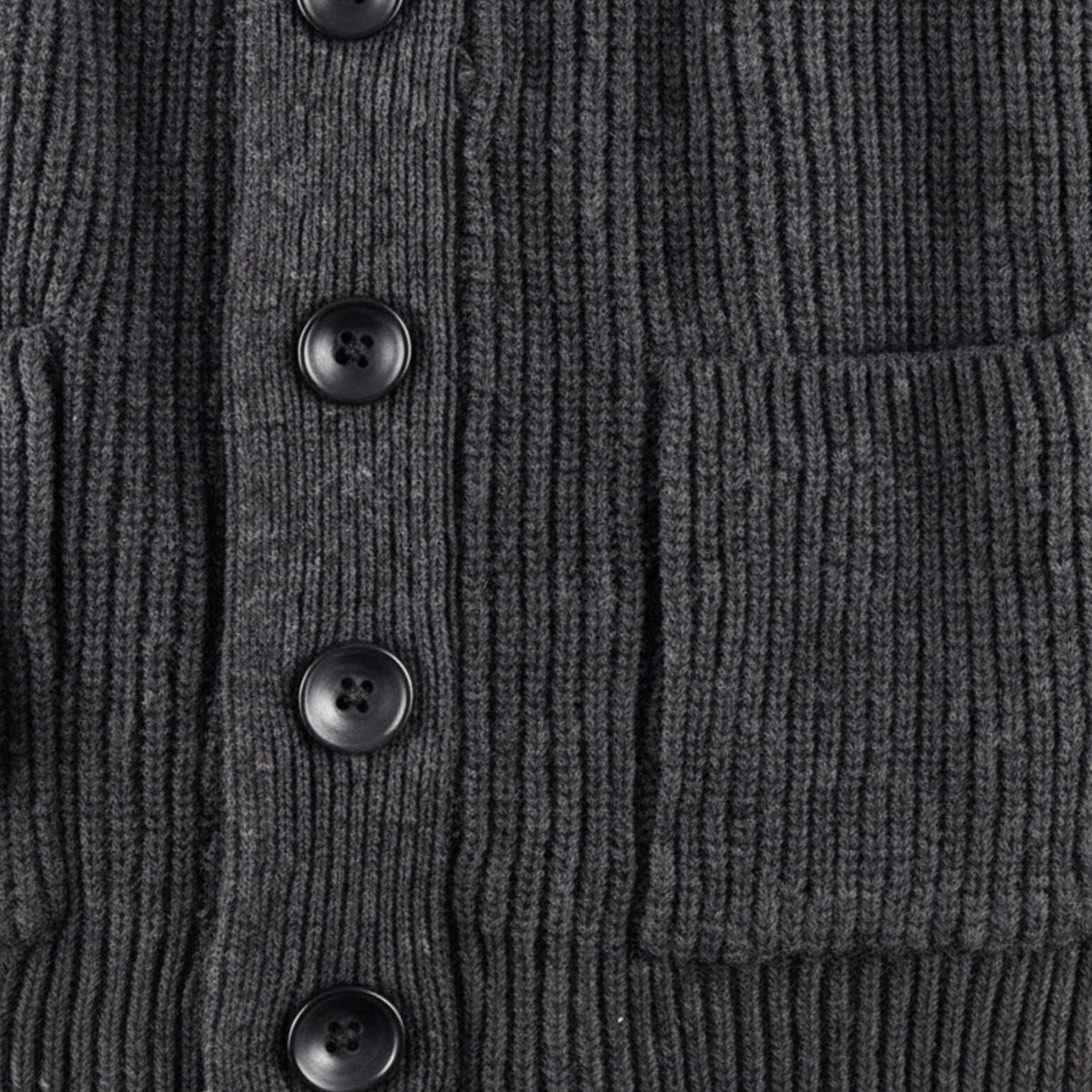 Dark gray chunky knit cardigan detail: black buttons and front patch pocket