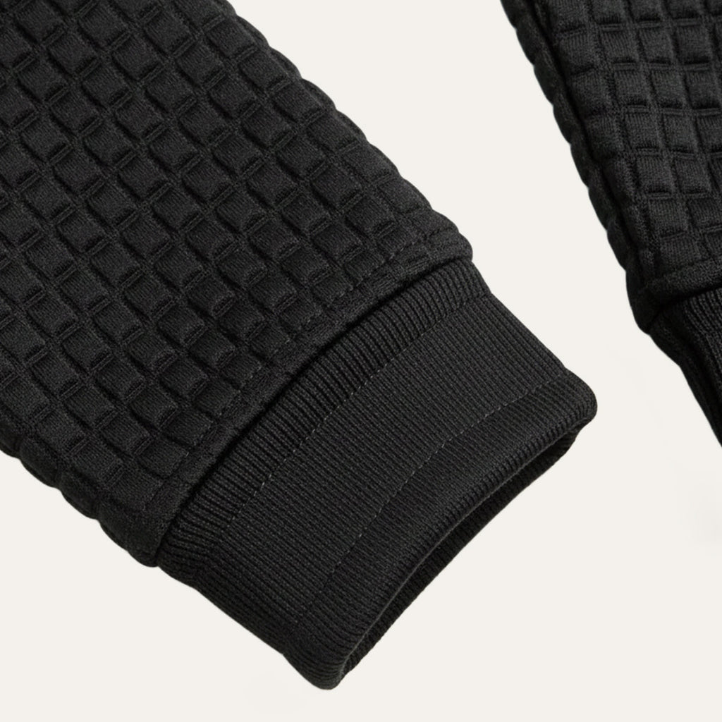 Men's black waffle-knit polo sweater sleeve cuff with ribbed trim