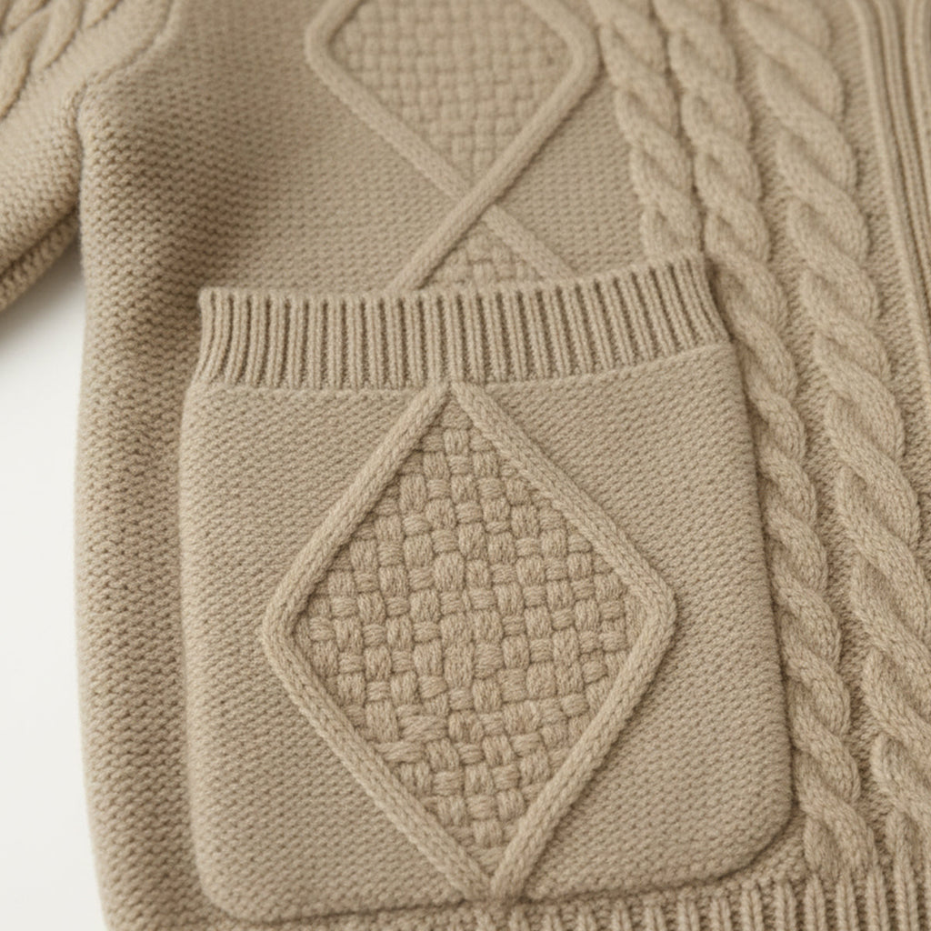 Beige cashmere cardigan close-up of cable patch, ribbed trim, and pocket panel