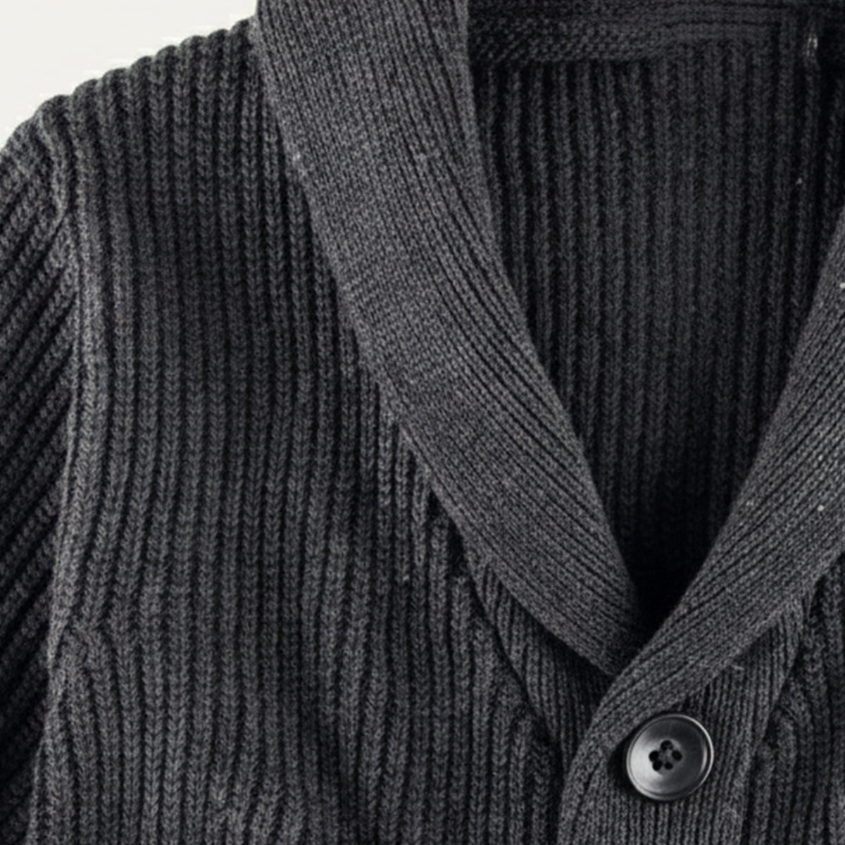 Dark gray chunky knit cardigan close-up with shawl collar and black buttons