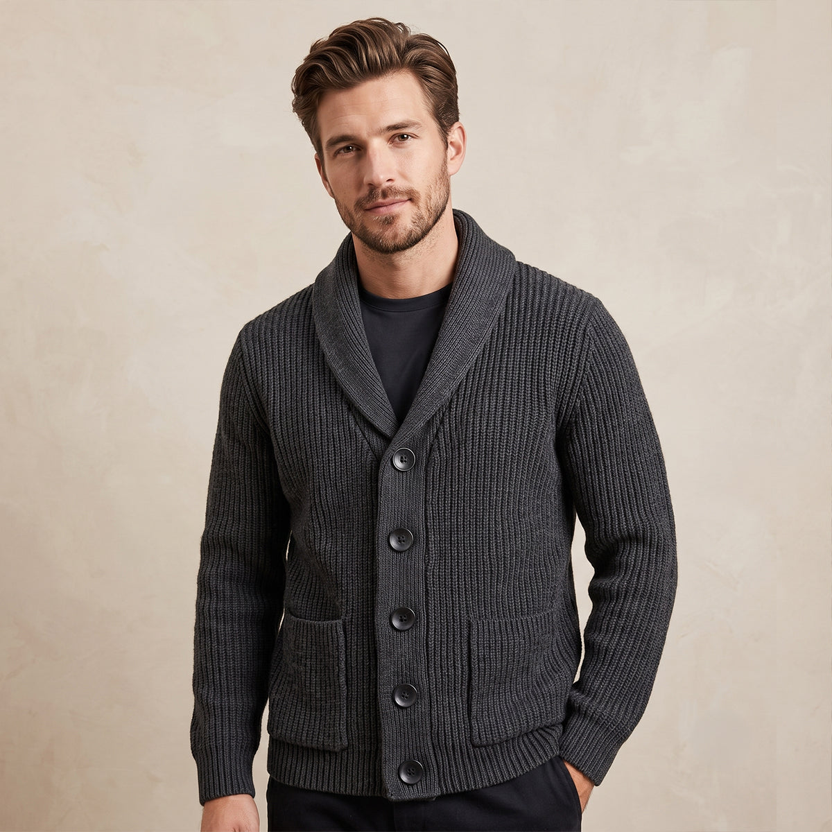 Men's dark gray wool shawl-collar knit cardigan on model, front pockets visible
