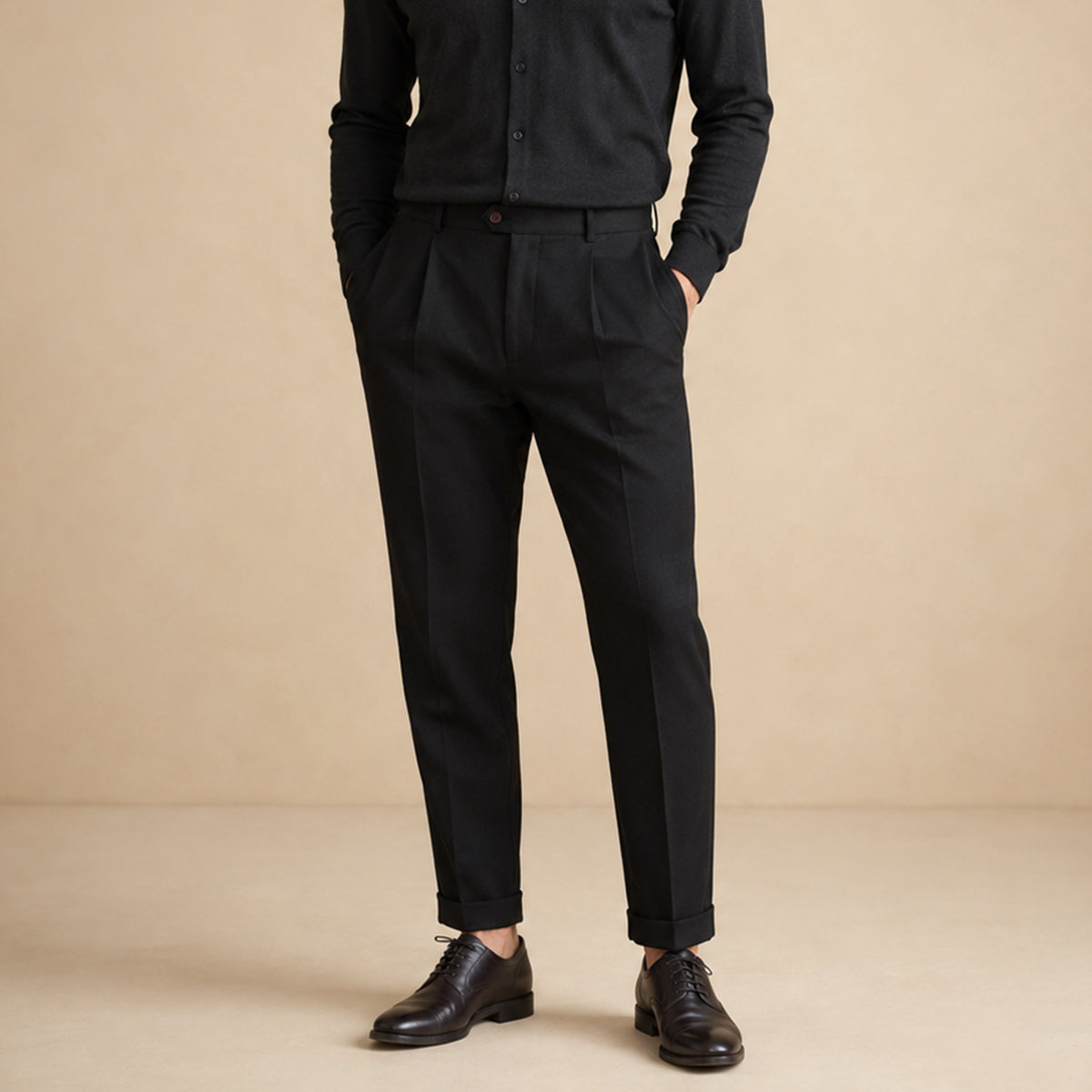 Men’s black classic-fit dress pants on model, flat-front pleats and belt loops