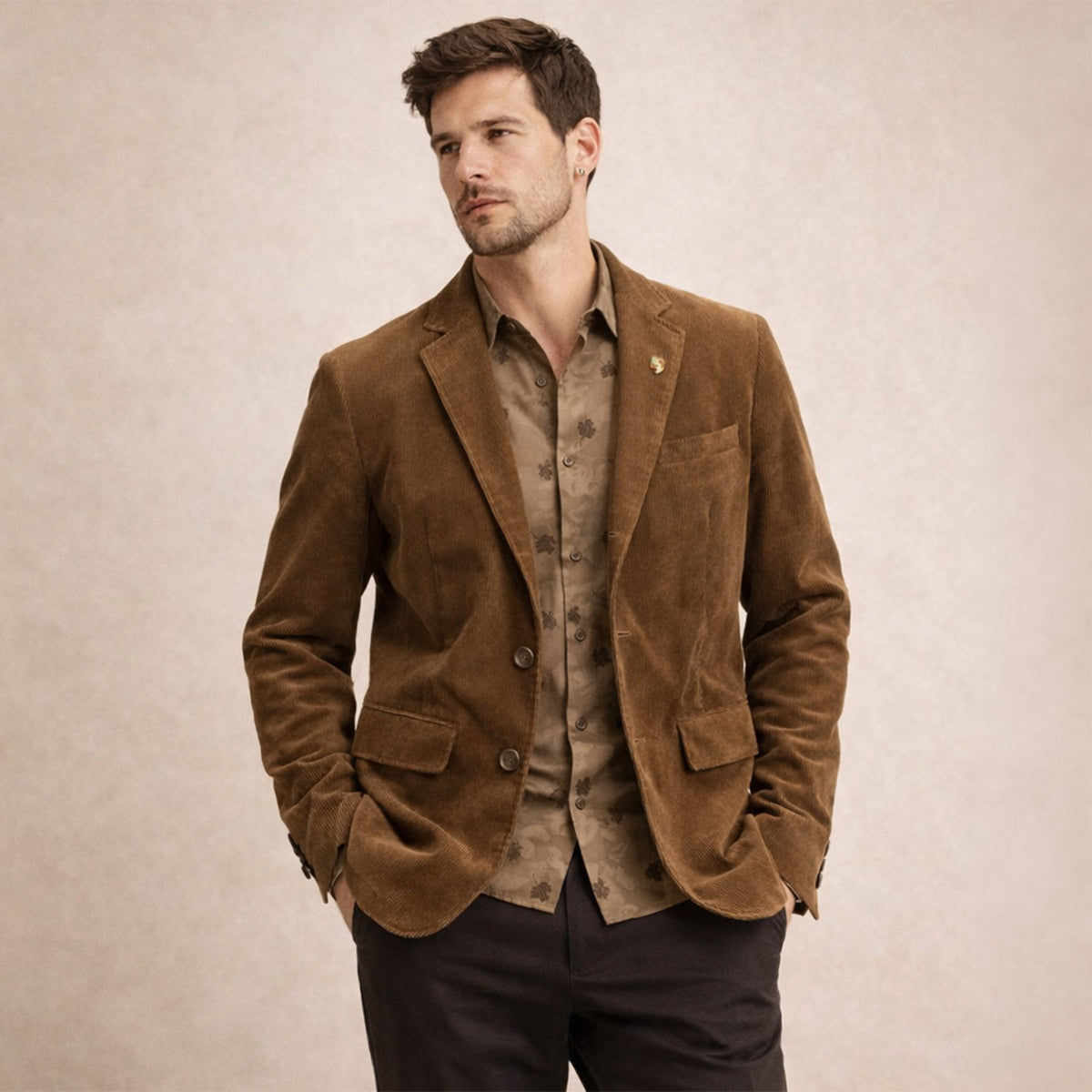 Brown corduroy blazer on model, with long sleeves, notch lapel, and button closure.