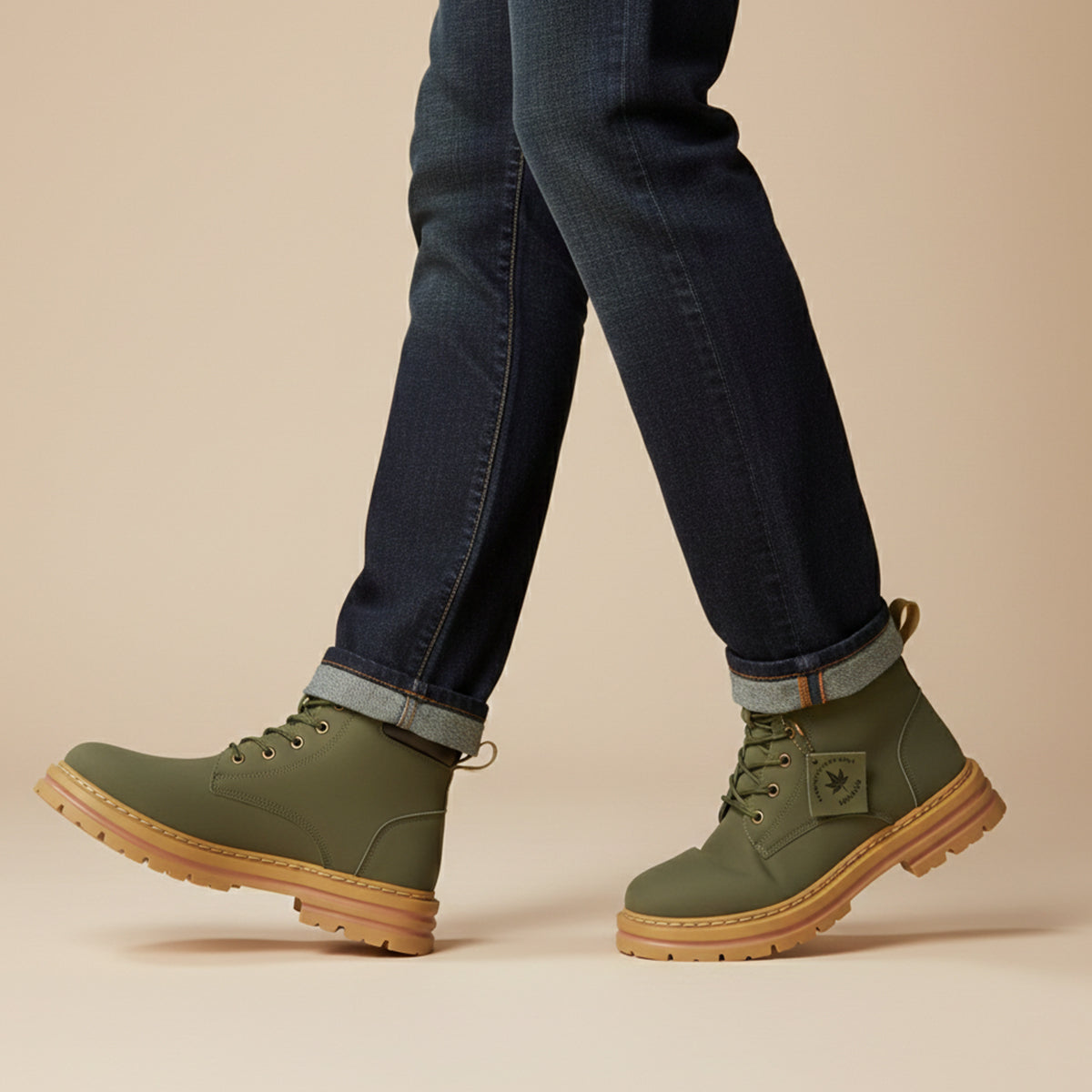 Men’s olive green fur-lined snow boots on feet with dark jeans, lace-up boots
