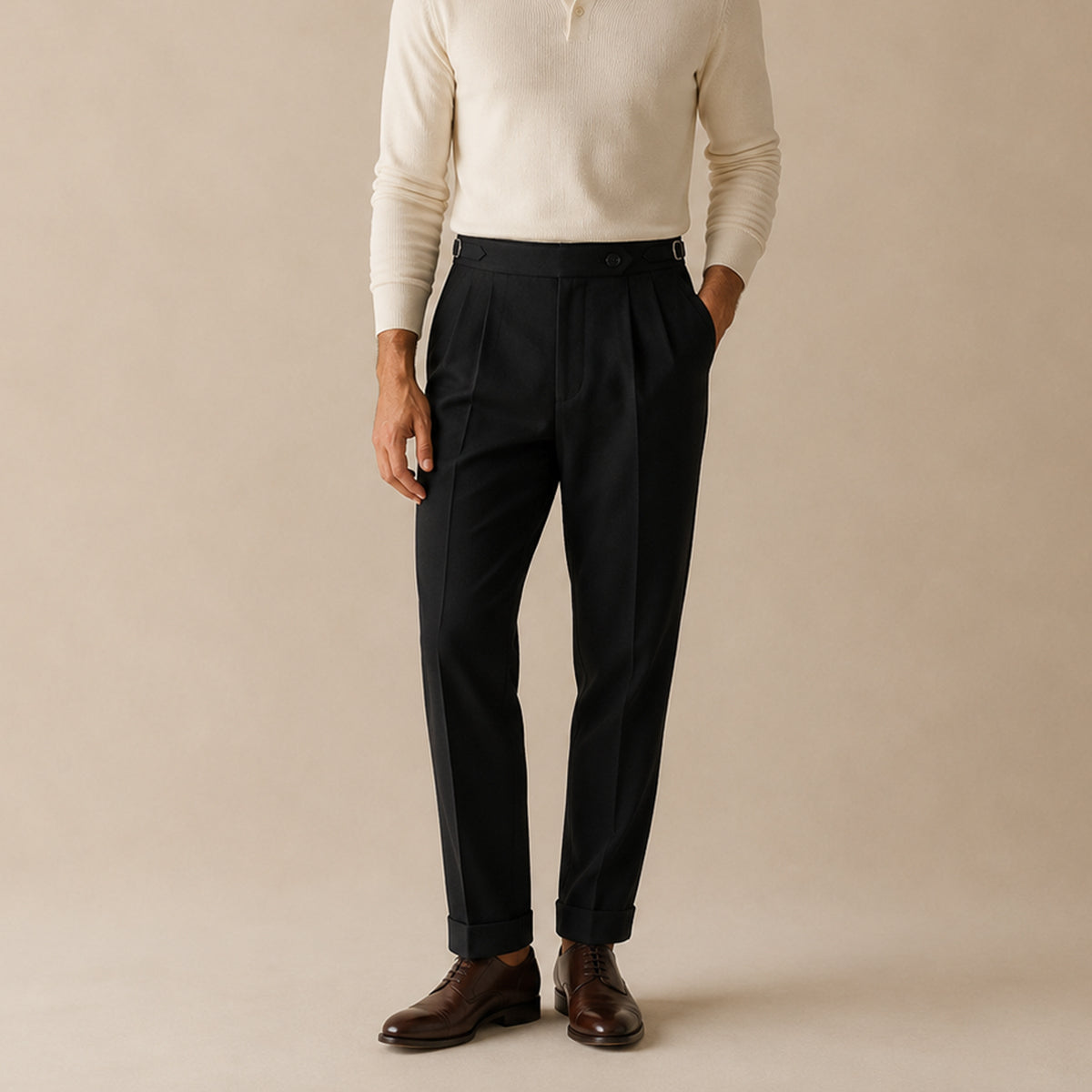 Black high-waist double-pleated trousers on model, tailored legs and cuffed hem.