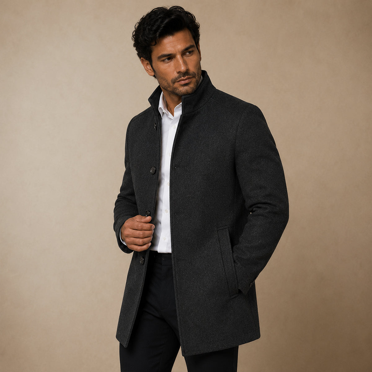 Dark wool coat styled open over a white shirt, showing stand collar and side pocket.