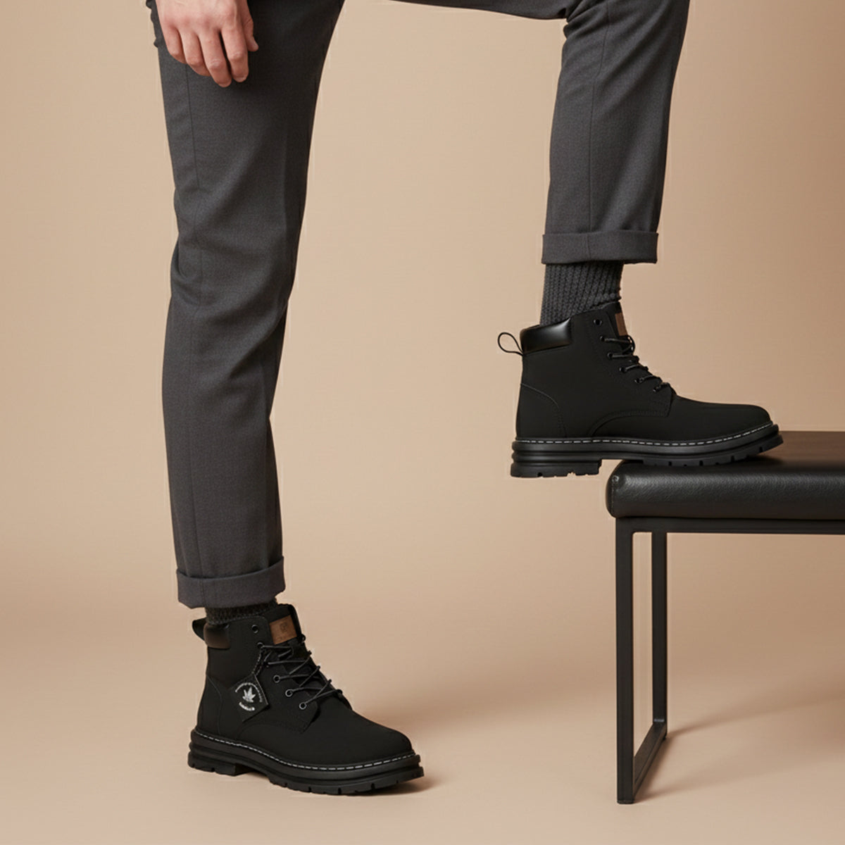 Men's black fur-lined snow boots with lace-up styling, worn with rolled pant cuffs