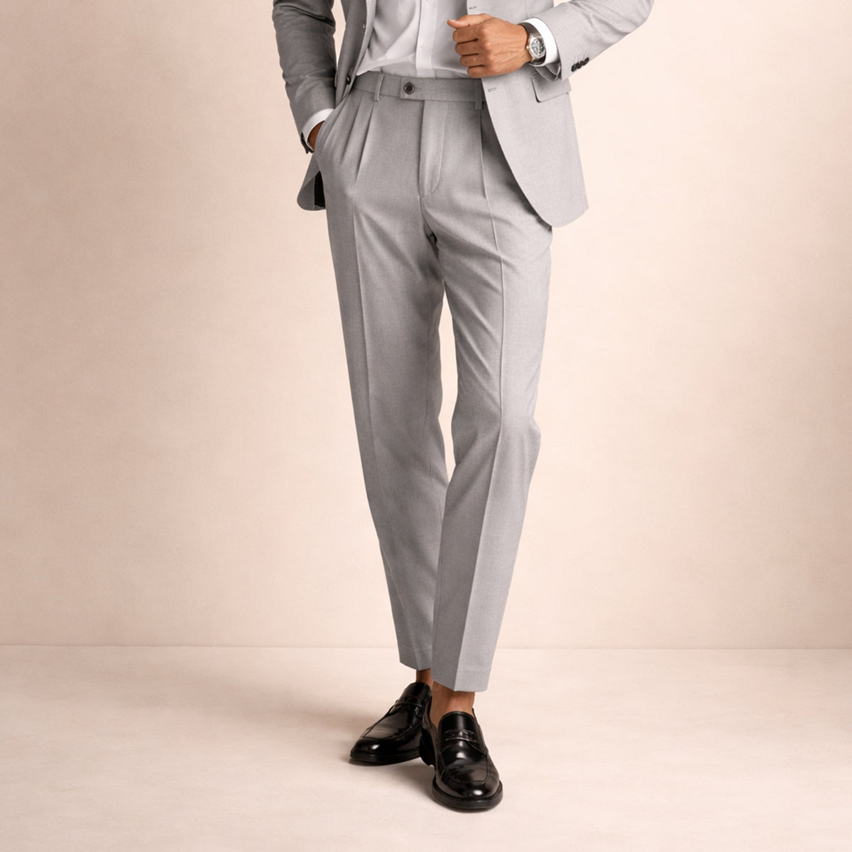 Men's light gray pleated trousers with crease front, belt loops, ankle length.