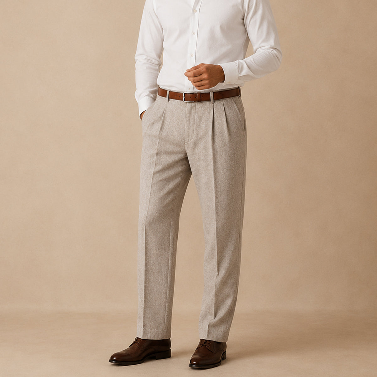 Men's beige pleated straight pants worn with a brown belt and dark leather shoes