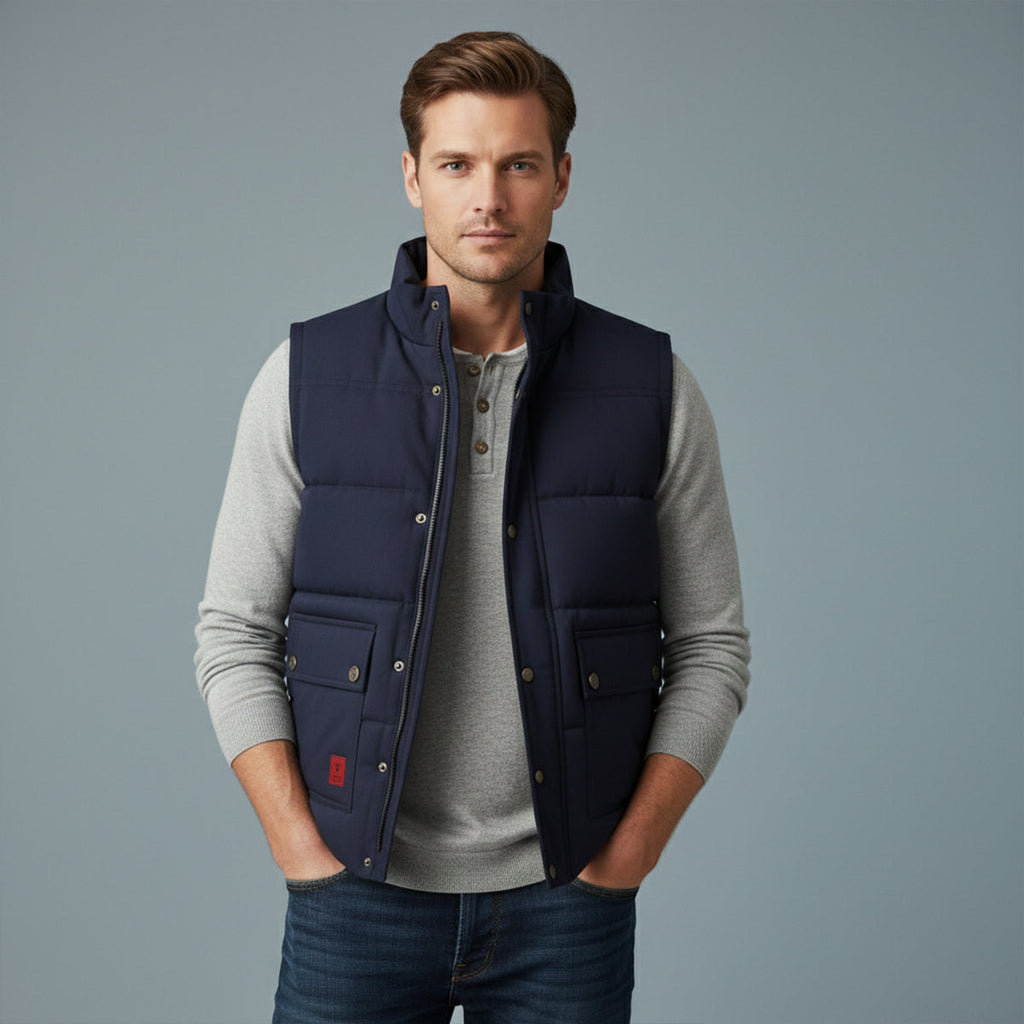 Men's fleece-lined winter vest in navy blue, worn over a sweater, button front and chest pockets