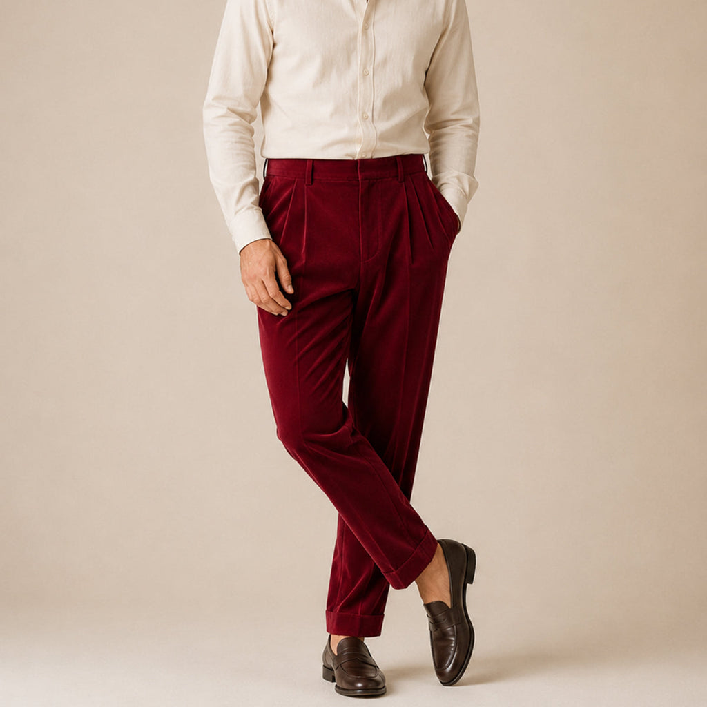 Men's burgundy velvet straight-fit pants on model with belt loops and tapered legs