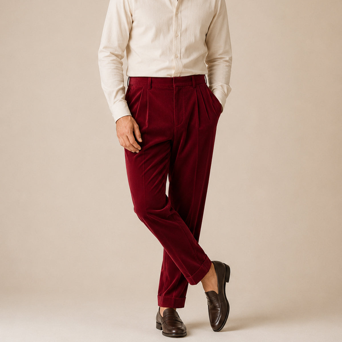 Men's burgundy velvet straight-fit pants on model with belt loops and tapered legs