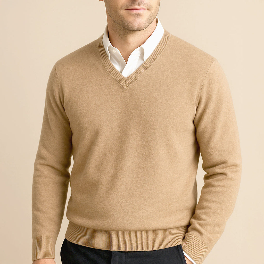 Men's beige cashmere V-neck sweater with ribbed neckline, worn over a white shirt.