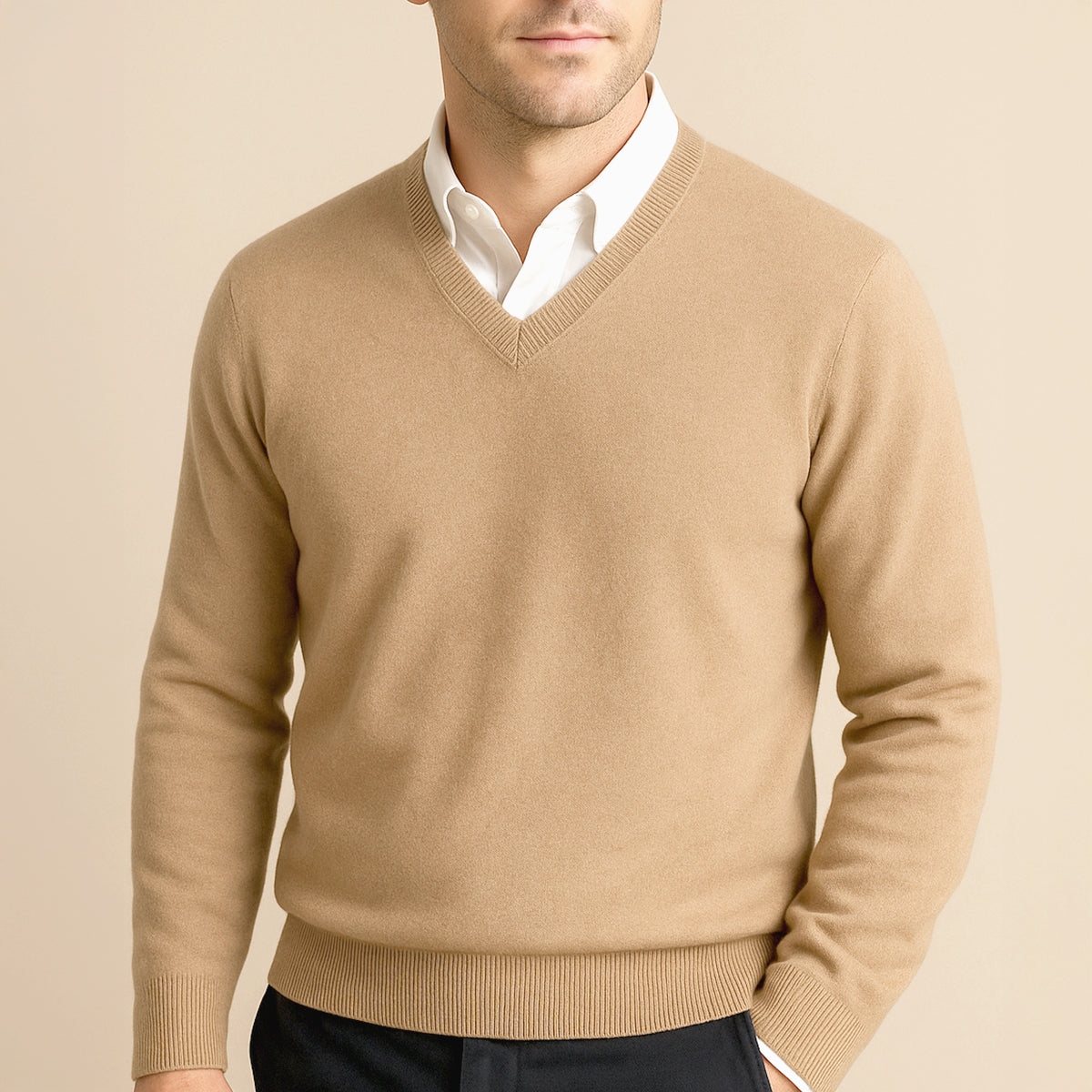 Men's beige cashmere V-neck sweater with ribbed neckline, worn over a white shirt.