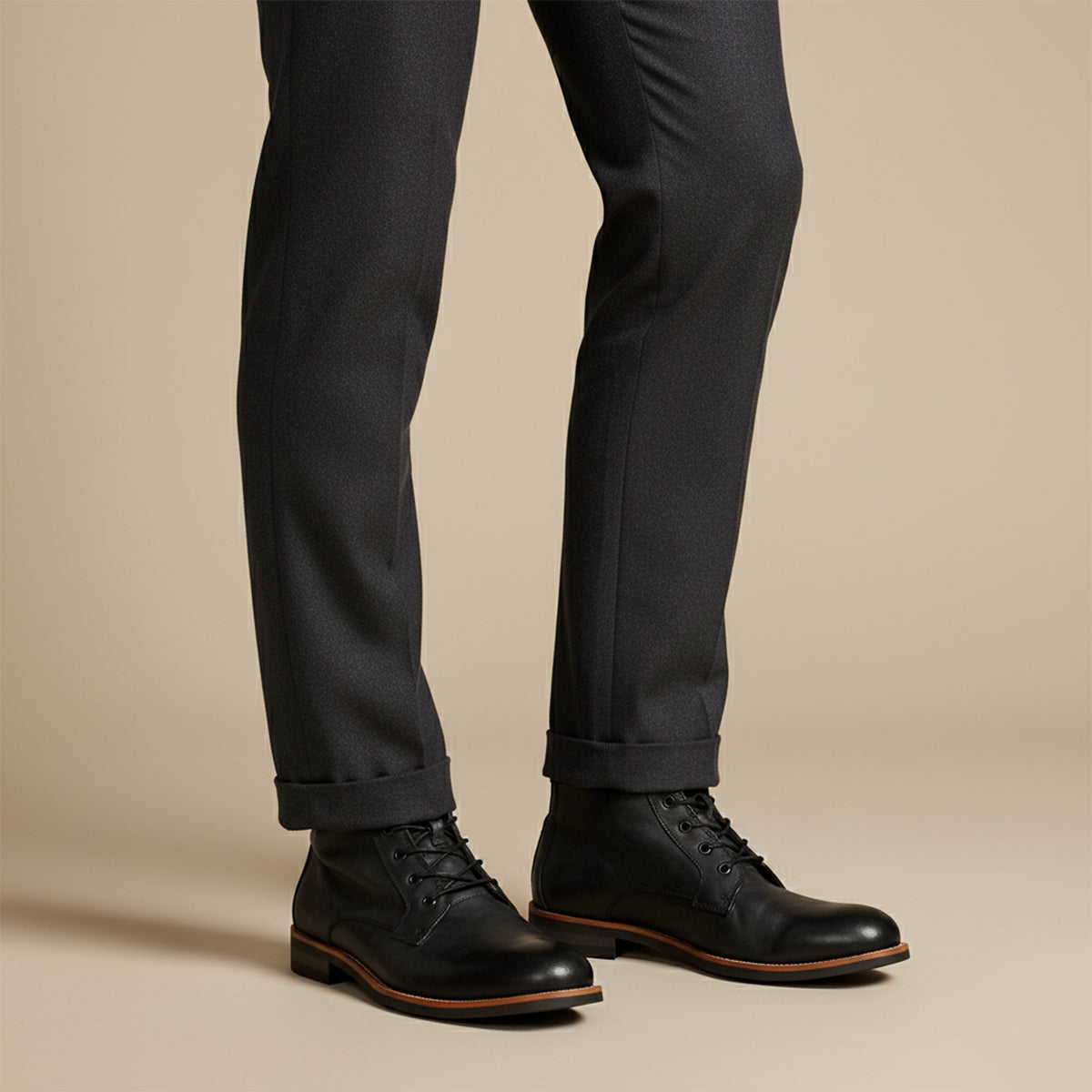 Men's black lace-up ankle boots with low block heel and dark trousers